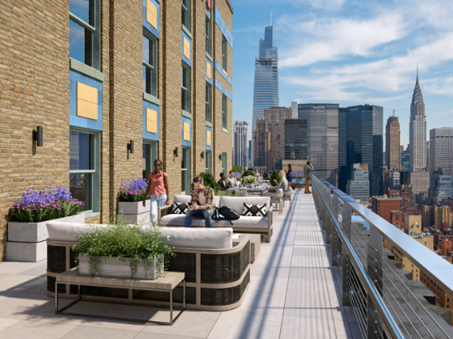 People enjoy an upper floor terrace with NYC views